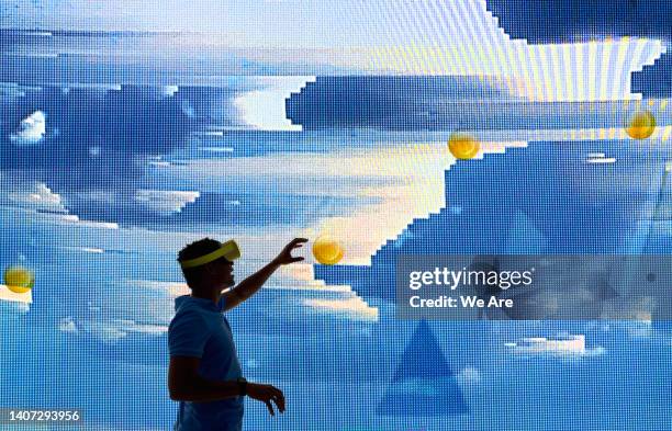 silhouette of a man interacting with virtual computer graphics - novidade imagens e fotografias de stock