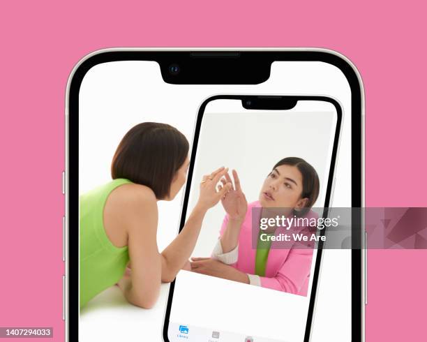 woman interacting with her digital twin - avatar stock pictures, royalty-free photos & images