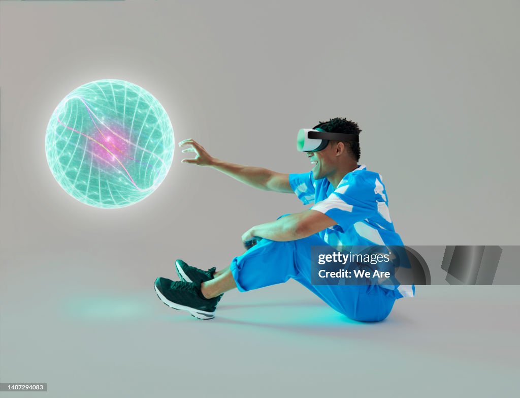 Man wearing VR headset reaching out with hand
