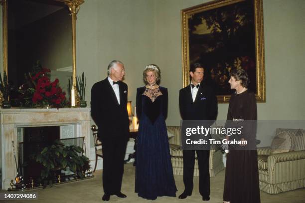 Princess Diana wearing a tiara and Prince Charles stand between two unidentified people at the government house in Melbourne, Australia, 6th November...