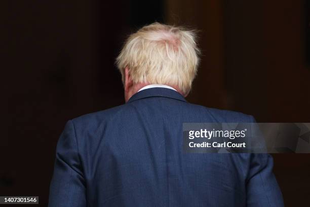 Prime Minister Boris Johnson returns inside after addressing the nation as he announces his resignation outside 10 Downing Street on July 7, 2022 in...