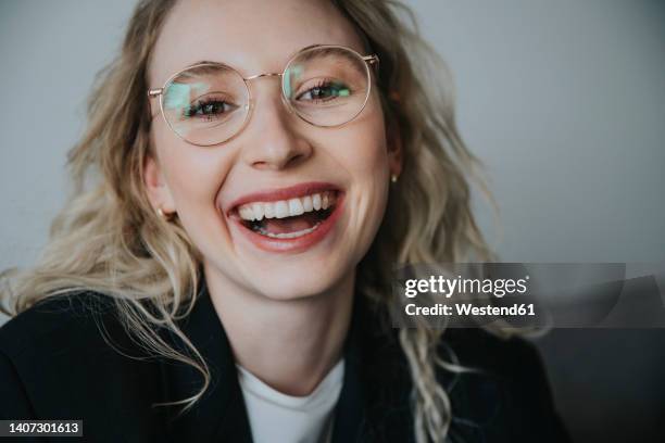 blond businesswoman laughing wearing eyeglasses - midsection stock pictures, royalty-free photos & images