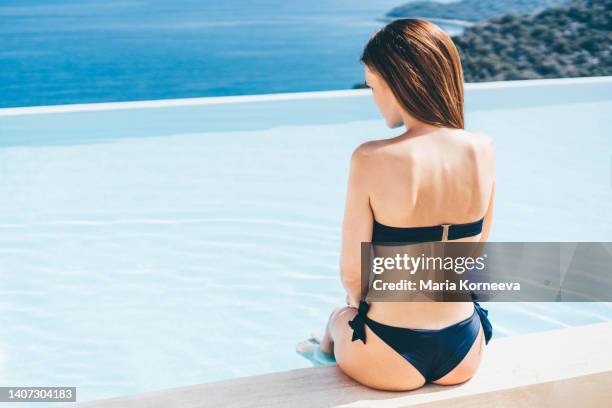 woman relaxing  in infinity pool. - caribbean dream stock pictures, royalty-free photos & images