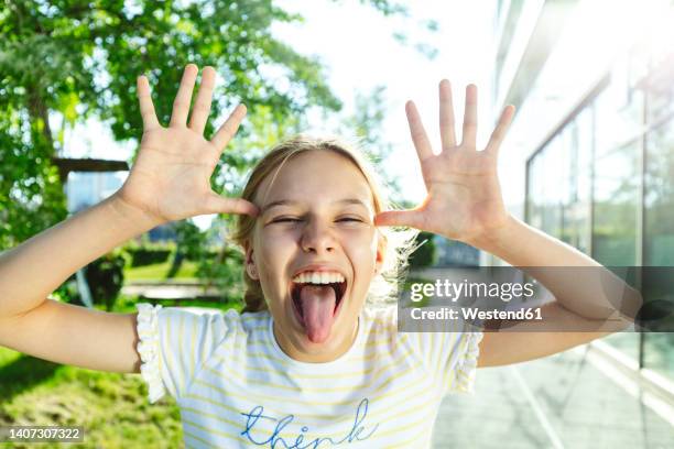 girl with blond hair sticking out tongue - teasing stock pictures, royalty-free photos & images