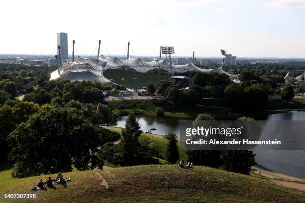 General view of the Olympic Stadium with the Great Olympic Lake at the Olympiapark on July 06, 2022 in Munich, Germany. The Olympiapark will host...