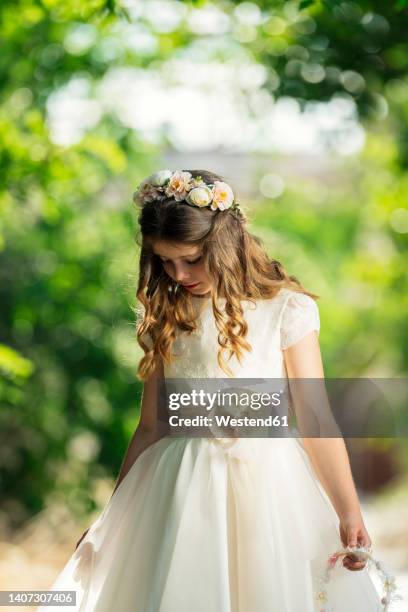 girl wearing communion dress in forest - heilige communie stockfoto's en -beelden