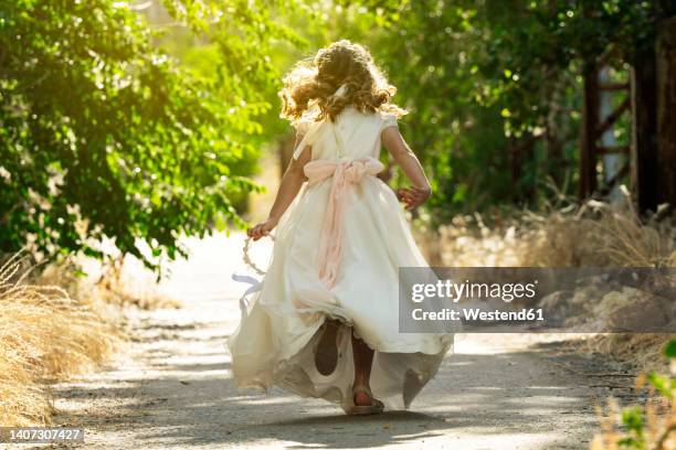 girl running on footpath in forest - heilige communie stockfoto's en -beelden