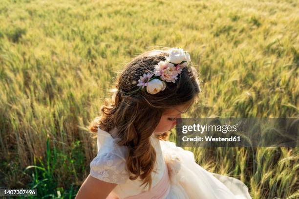 girl wearing communion dress in wheat field - communion stock pictures, royalty-free photos & images