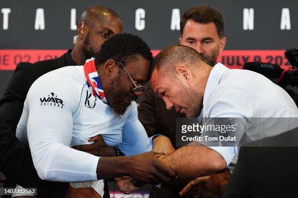 Dereck Chisora and Kubrat Pulev clash during the Chisora v Pulev 2 Press Conference at Canary Riverside Plaza Hotel on July 07, 2022 in London,...