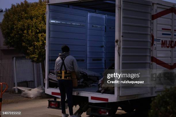 house moving process. owner and moving staff packing, protecting and transporting furniture and movables to moving truck - hombres maduros stock pictures, royalty-free photos & images