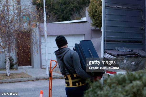 house moving process. owner and moving staff packing, protecting and transporting furniture and movables to moving truck - hombres maduros stock pictures, royalty-free photos & images