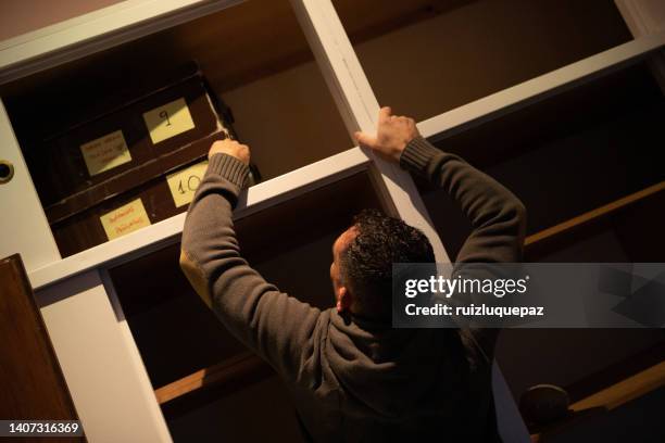 house moving process. owner and moving staff packing, protecting and transporting furniture and movables to moving truck - hombres maduros stock pictures, royalty-free photos & images