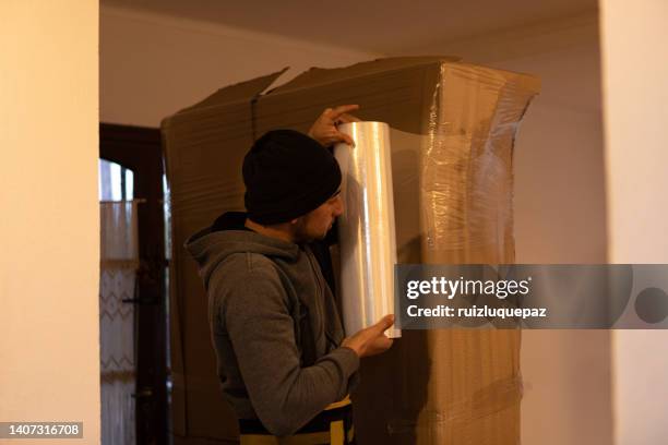 house moving process. owner and moving staff packing, protecting and transporting furniture and movables to moving truck - vehículo terrestre stock pictures, royalty-free photos & images