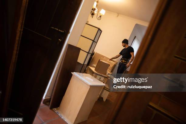 house moving process. owner and moving staff packing, protecting and transporting furniture and movables to moving truck - transporte de carga stock pictures, royalty-free photos & images