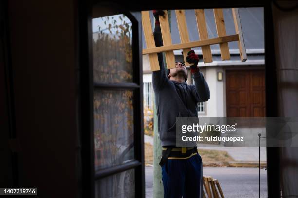 house moving process. owner and moving staff packing, protecting and transporting furniture and movables to moving truck - hombres maduros stock pictures, royalty-free photos & images