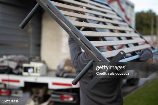 house moving process. owner and moving staff packing, protecting and transporting furniture and movables to moving truck - transporte de carga stock pictures, royalty-free photos & images