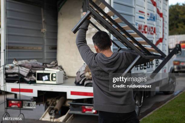 house moving process. owner and moving staff packing, protecting and transporting furniture and movables to moving truck - vehículo terrestre stock pictures, royalty-free photos & images