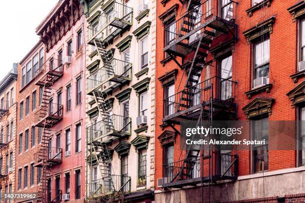 apartment buildings with fire escape in east village, new york city, usa - east village stock-fotos und bilder