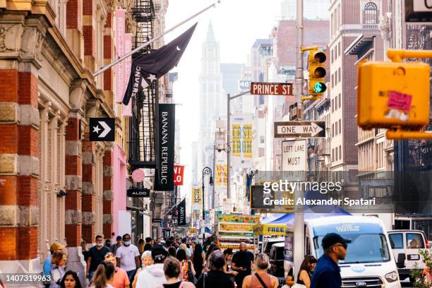 crowds of people on broadway in soho, new york city, usa - broadway manhattan stock pictures, royalty-free photos & images