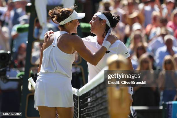 Match winner Ons Jabeur of Tunisia embraces Tatjana Maria of German at the net following their Women's Singles Semi-Final match on day eleven of The...