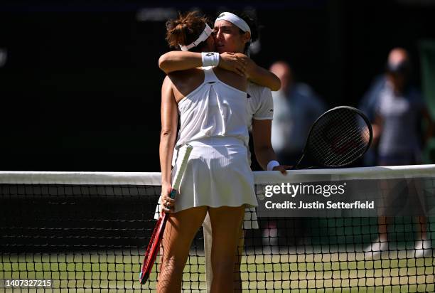 Match winner Ons Jabeur of Tunisia embraces Tatjana Maria of German at the net following their Women's Singles Semi-Final match on day eleven of The...