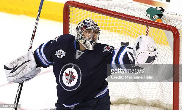 Goaltender Ondrej Pavelec of the Winnipeg Jets blocks a shot on goal by the Buffalo Sabres in NHL action at the MTS Centre on March 5, 2012 in...