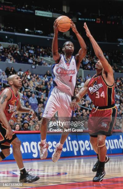 Keyon Dooling, Point Guard for the Los Angeles Clippers attempts a jump shot to the hoop over Corliss Williamson, Small Forward and Power Forward for...