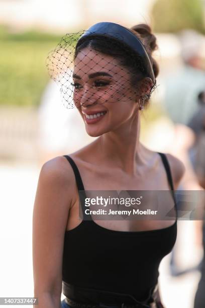 Heart Evangelista seen wearing black shiny leather headband with a black fishnet, silver and diamonds earrings, a black square-neck tank-top from...