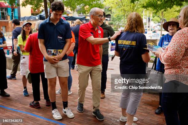 Maryland Democratic gubernatorial candidate Tom Perez talks with campaign volunteers during the first day of early voting in the state outside the...