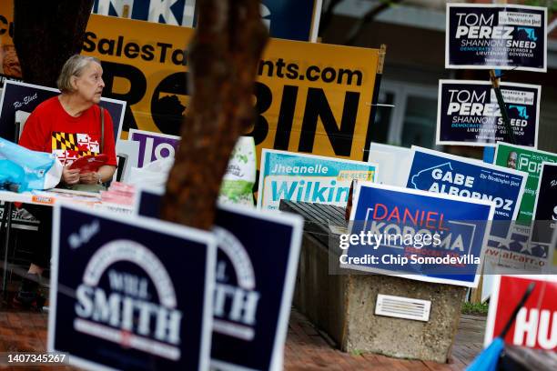 Campaign signs compete for space during the first day of early voting in the state outside the Silver Spring Civic Building at Veterans Plaza on July...