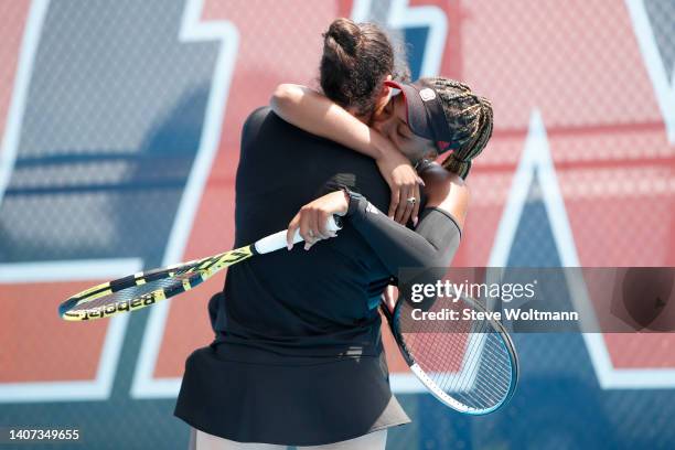 Jaeda Daniel of the NC State Wolfpack celebrates with Nell Miller of the NC State Wolfpack after defeating the Miami Hurricanes during the Division I...