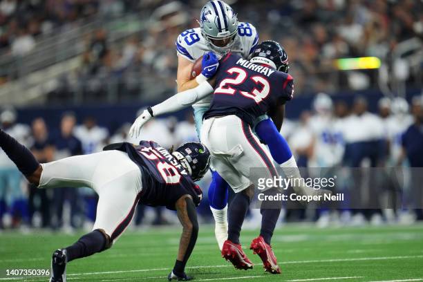 Eric Murray of the Houston Texans tackles Blake Jarwin of the Dallas Cowboys during an NFL game at AT&T Stadium on August 21, 2021 in Arlington,...