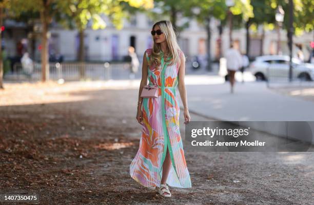 Mandy Bork seen wearing brown sunglasses from Tom Ford, a colorful buttoned / pleated / sleeveless long dress from Emilio Pucci, a pale pink Hermes...