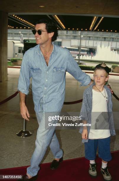 Pierce Brosnan smiles beside his young son Sean Brosnan at the premiere of "Home Alone 2: Lost in New York" in Century City, California, United...