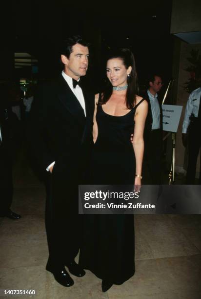 Pierce Brosnan in a suit and bow tie stands with partner Keely Shaye Smith at the Ark Trust's 10th Annual Genesis Awards, held at the Beverly Hilton...