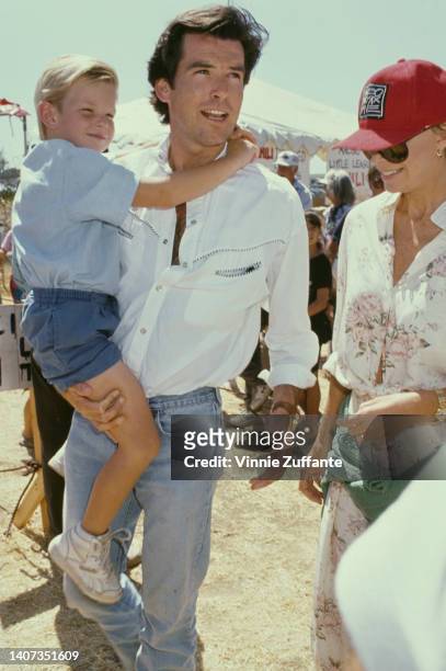 Pierce Brosnan carries his son Sean beside wife Cassandra Harris at the 8th Annual Malibu Kiwanis Chili Cook-off Carnival & Fair, held at the Civic...