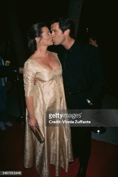 Pierce Brosnan kisses his girlfriend Keely Shaye Smith during the premiere of "Michael Collins" at the Academy of Motion Picture Arts & Sciences in...
