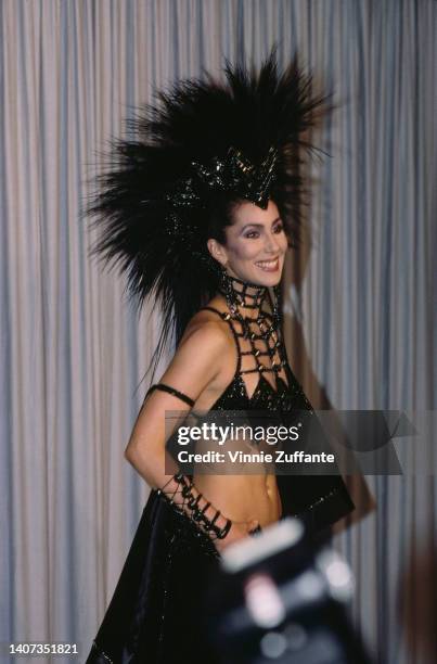 Cher wears a large feather headpiece at the 58th Annual Academy Awards held at Dorothy Chandler Pavillion in Los Angeles, California, United States...