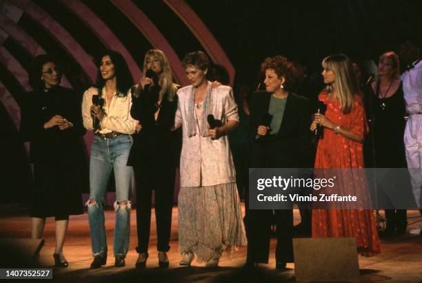 Lily Tomlin, Cher , Goldie Hawn, Meyrl Streep, Bette Midler and Olivia Newton - John sing "What A Wonderful World" on stage during a benefit for...