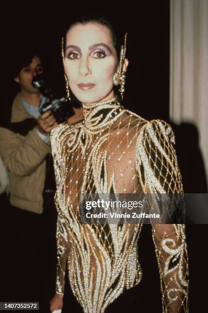 Cher wears a custom sequin black and sheer outfit by Bob Mackie at the Met Gala exhibition of "Costumes of Royal India" in New York City, United...