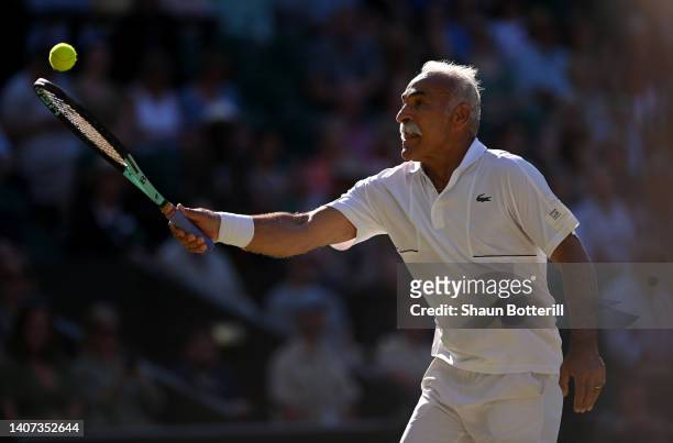 Mansour Bahrami of France controls the ball against Todd Woodbridge of Australia and Cara Black of Zimbabwe during their Invitation Mixed Doubles...