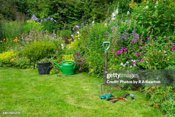 garden tools beside a mixed border in an english country garden - july stock pictures, royalty-free photos & images