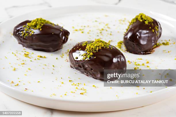 chocolate covered dates - chocolate dipped stock pictures, royalty-free photos & images