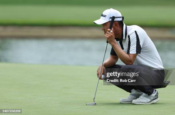 Michael Kim of the United States lines up a putt on the 18th green during the first round of the Barbasol Championship at Keene Trace Golf Club on...