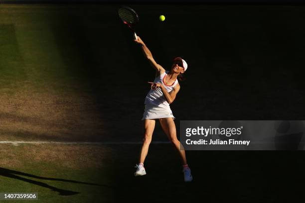 Cara Black of Zimbabwe plays an overhead shot with partner Todd Woodbridge of Australia against Mansour Bahrami of France and Conchita Martinez of...