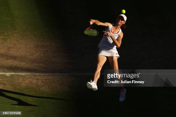 Cara Black of Zimbabwe plays an overhead shot with partner Todd Woodbridge of Australia against Mansour Bahrami of France and Conchita Martinez of...