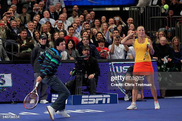 Golfer Rory McIlroy of Northern Ireland joins his girlfriend Caroline Wozniacki of Denmark on the court and returns against Maria Sharapova of Russia...