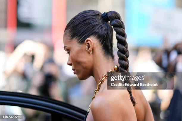 Guest wears gold earrings, a gold large chain necklace , outside the Schiaparelli show, during Paris Fashion Week - Haute Couture Fall Winter 2022...