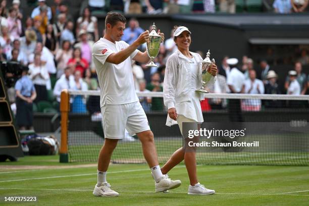 Desirae Krawczyk of The United States and partner Neal Skupski of Great Britain hold up their Trophies after winning the Mixed Doubles Final against...