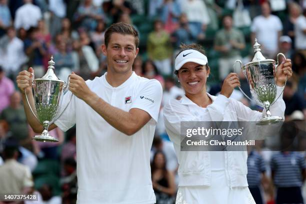 Desirae Krawczyk of The United States and partner Neal Skupski of Great Britain hold up their Trophies after winning the Mixed Doubles Final against...